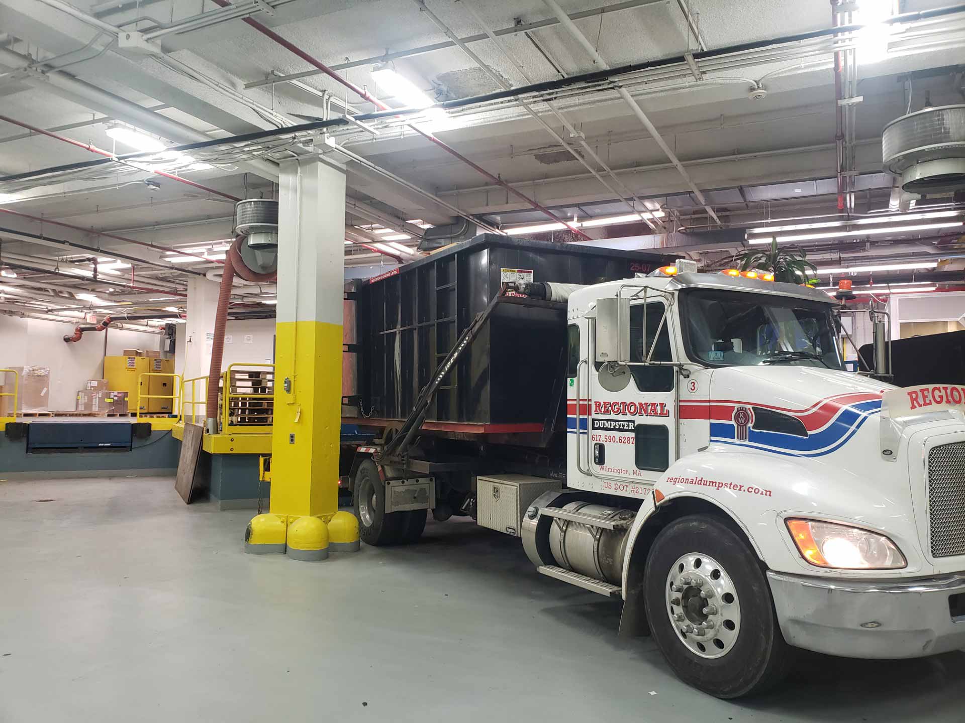Regional Dumpster Rental truck parked in a garage